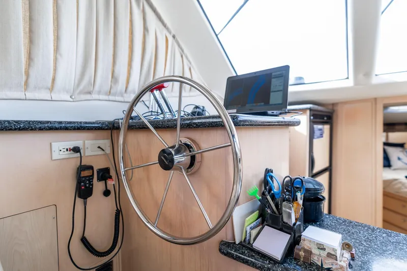 Slide: The Image of Steering wheel and navigation setup inside 2000 Carver 404 Cockpit Motor Yacht. - 10