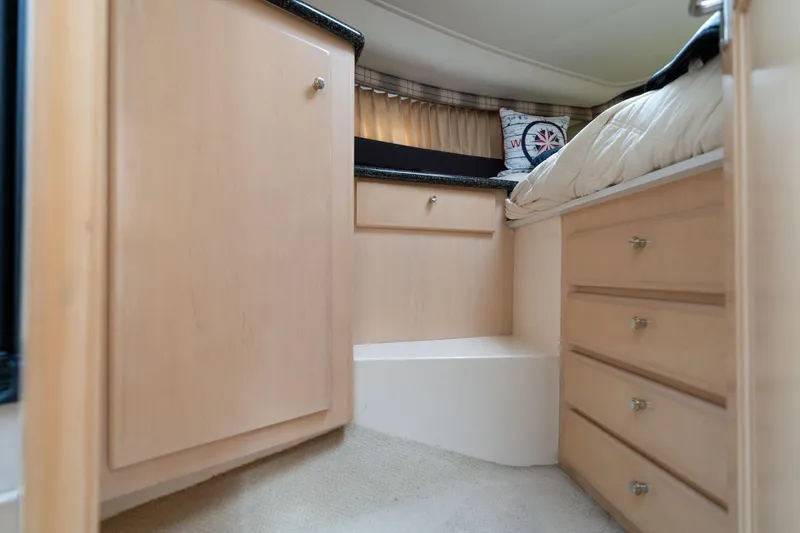 Slide: The Image of Interior cabin of 2000 Carver 404 Cockpit Motor Yacht with wooden cabinetry and bedding. - 14