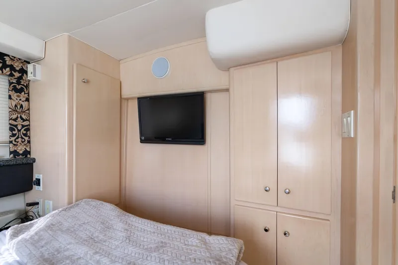 Slide: The Image of Interior of 2000 Carver 404 Cockpit Motor Yacht with TV and cabinets. - 18