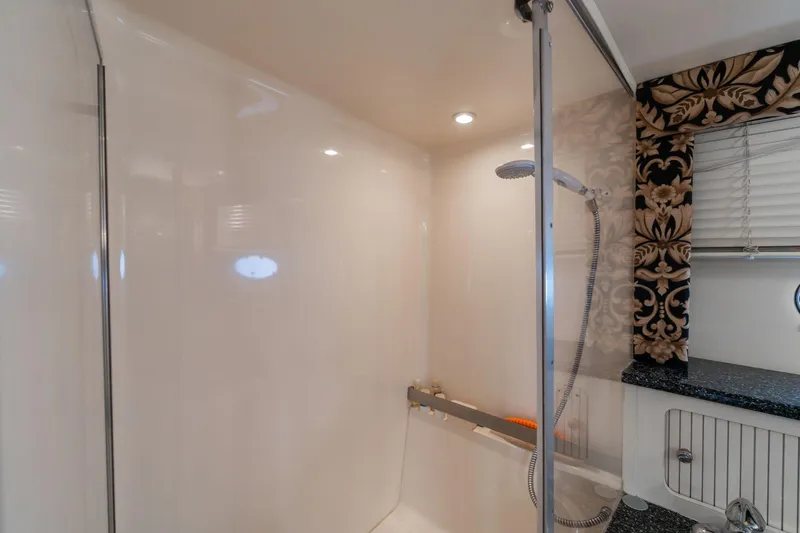 Slide: The Image of Bathroom interior of 2000 Carver 404 Cockpit Motor Yacht with shower and decorative curtain. - 20