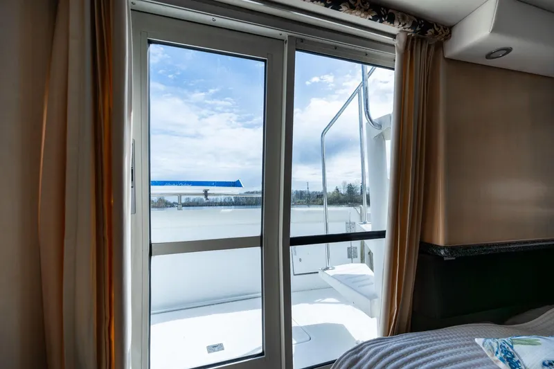 Slide: The Image of Interior view of 2000 Carver 404 Cockpit Motor Yacht with sliding glass door and outdoor deck. - 21