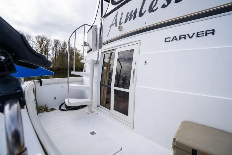 Slide: The Image of 2000 Carver 404 Cockpit Motor Yacht with spiral staircase and sliding door on deck. - 22