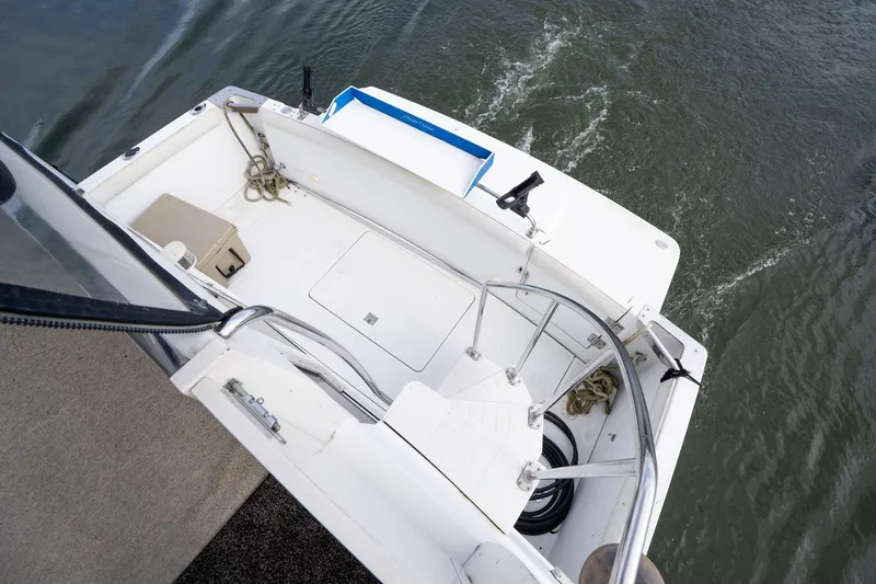 Slide: The Image of 2000 Carver 404 Cockpit Motor Yacht deck view with water in background. - 23