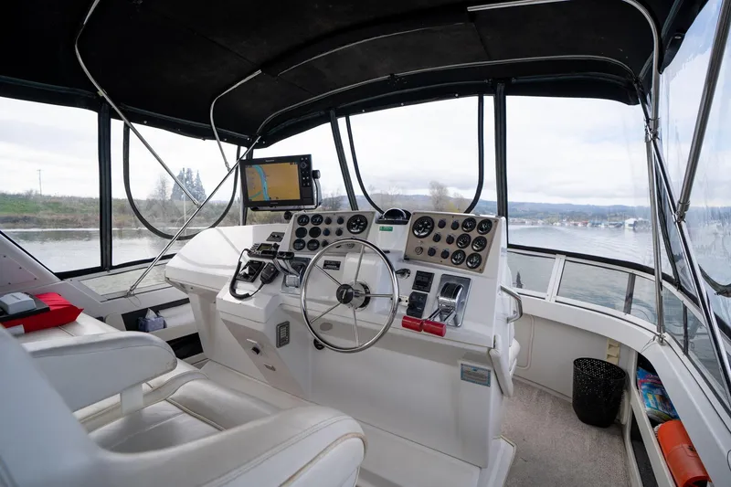 Slide: The Image of Interior of 2000 Carver 404 Cockpit Motor Yacht with steering wheel and navigation equipment. - 26