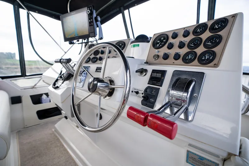 Slide: The Image of Helm of 2000 Carver 404 Cockpit Motor Yacht with steering wheel and control panel. - 27