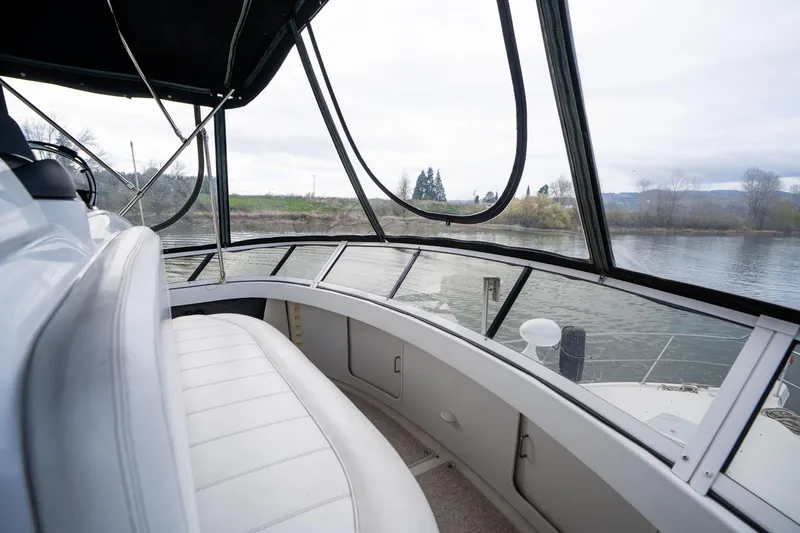 Slide: The Image of Interior view of 2000 Carver 404 Cockpit Motor Yacht with river scenery. - 30
