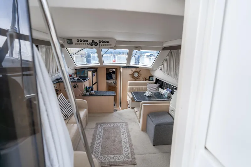 Slide: The Image of Interior of 2000 Carver 404 Cockpit Motor Yacht with helm and seating area. - 4