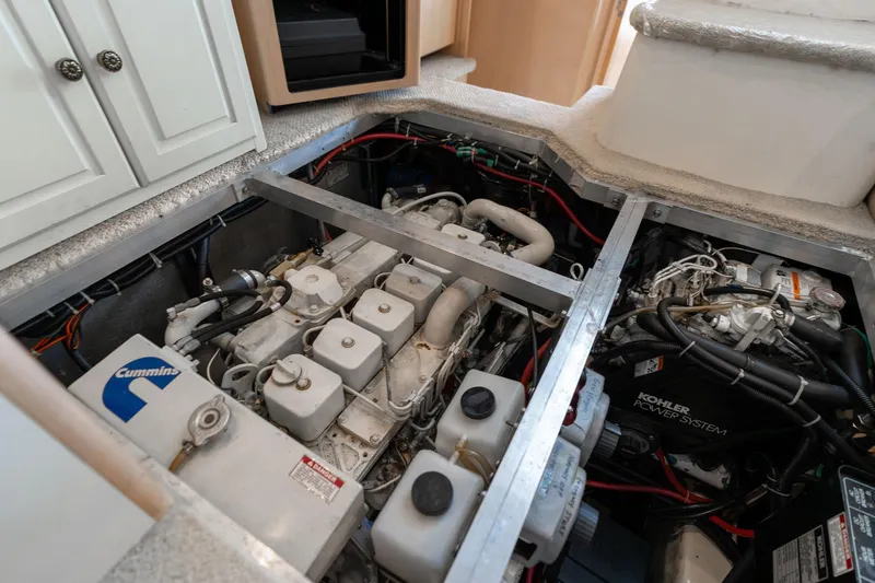 Slide: The Image of Engine compartment of a 2000 Carver 404 Cockpit Motor Yacht with Cummins and Kohler systems. - 49