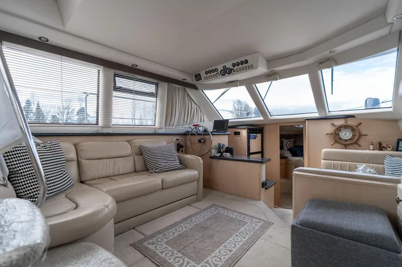 Slide: The Image of Luxurious interior of 2000 Carver 404 Cockpit Motor Yacht with plush seating and helm. - 5