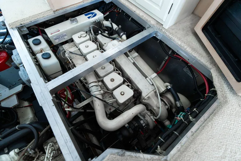 Slide: The Image of Engine compartment of a 2000 Carver 404 Cockpit Motor Yacht, showcasing mechanical components. - 50