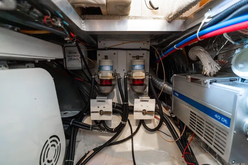 Slide: The Image of Engine room of 2000 Carver 404 Cockpit Motor Yacht with mechanical components. - 52