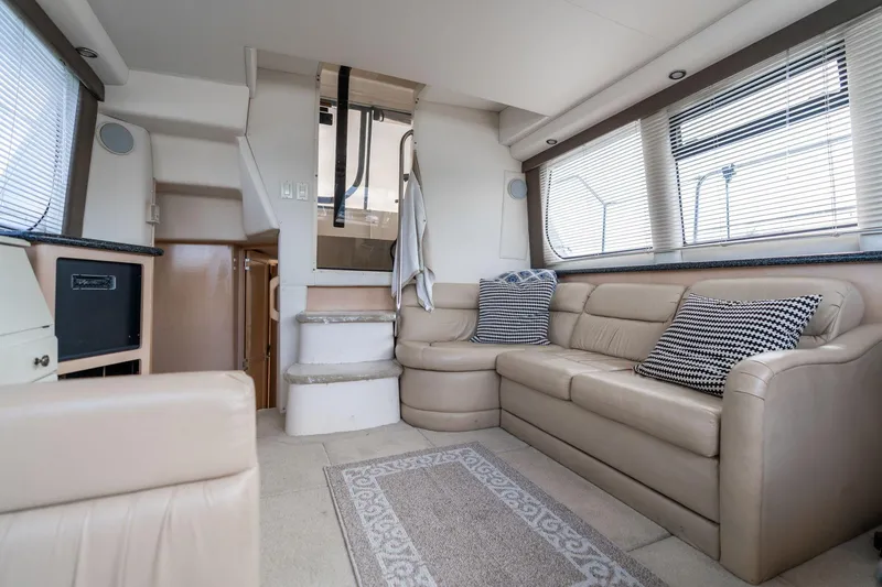 Slide: The Image of Interior of 2000 Carver 404 Cockpit Motor Yacht with beige seating and striped cushions. - 8