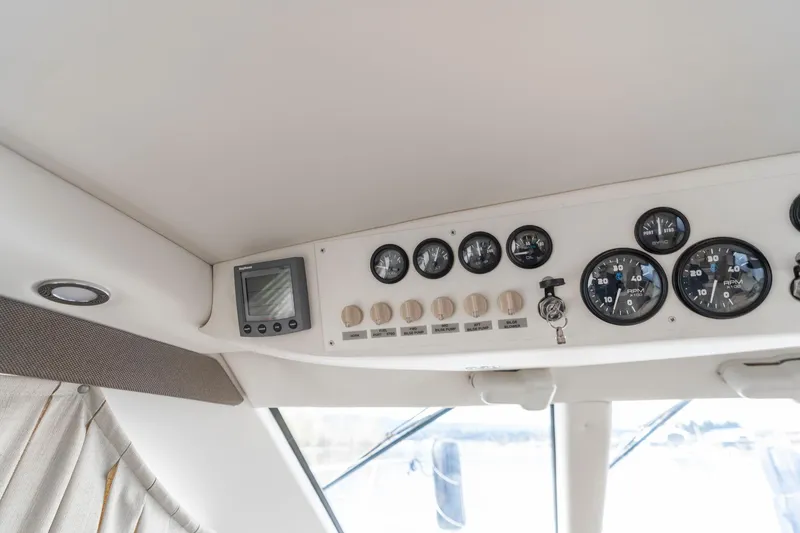Slide: The Image of Dashboard of 2000 Carver 404 Cockpit Motor Yacht with gauges and controls. - 9