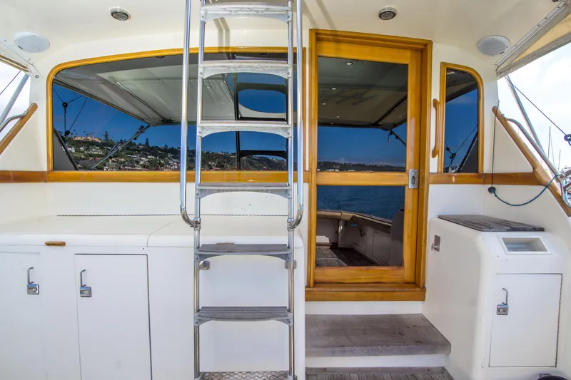 Slide: The Image of 1986 Ocean Yachts 48 Super Sport yacht interior with ladder and wooden door. - 10
