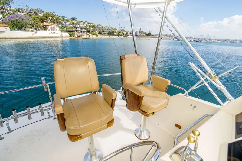 Slide: The Image of Flybridge seating on 1986 Ocean Yachts 48 Super Sport overlooking marina and coastal homes. - 14