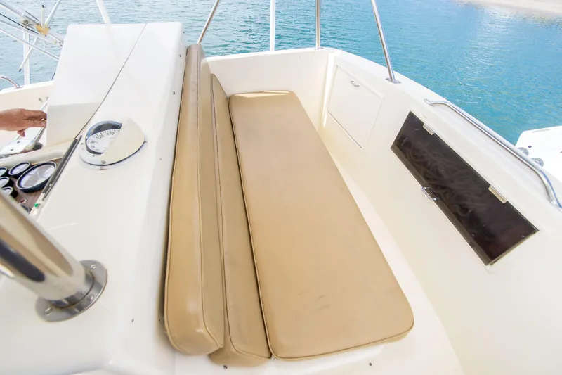 Slide: The Image of 1986 Ocean Yachts 48 Super Sport cockpit with beige seating and control panel. - 16