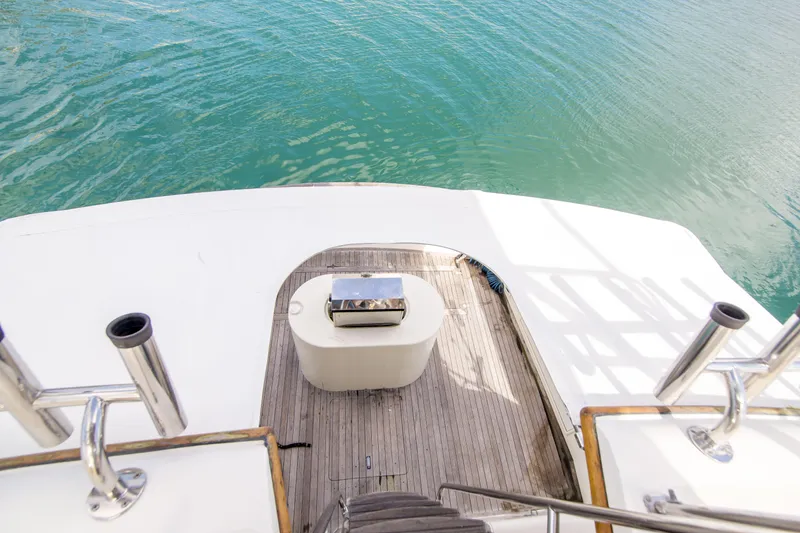 Slide: The Image of 1986 Ocean Yachts 48 Super Sport yacht deck with ocean view and fishing rod holders. - 17