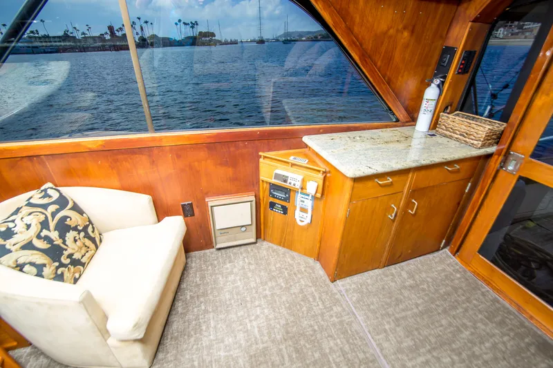 Slide: The Image of Interior of 1986 Ocean Yachts 48 Super Sport with chair and cabinetry by window. - 20