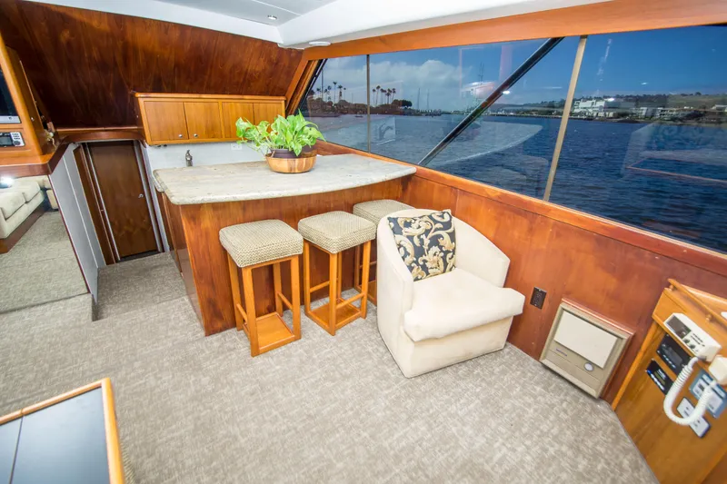 Slide: The Image of Luxurious interior of 1986 Ocean Yachts 48 Super Sport with bar and scenic window view. - 22