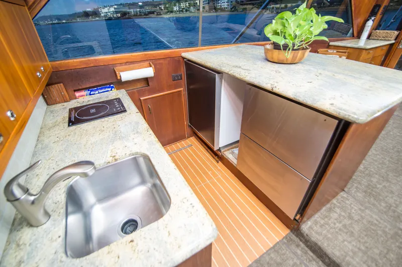 Slide: The Image of Luxurious 1986 Ocean Yachts 48 Super Sport kitchen with modern amenities and ocean view. - 24