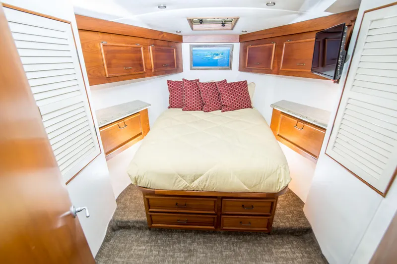 Slide: The Image of Luxurious cabin interior of 1986 Ocean Yachts 48 Super Sport with cozy bed and wooden cabinetry. - 25