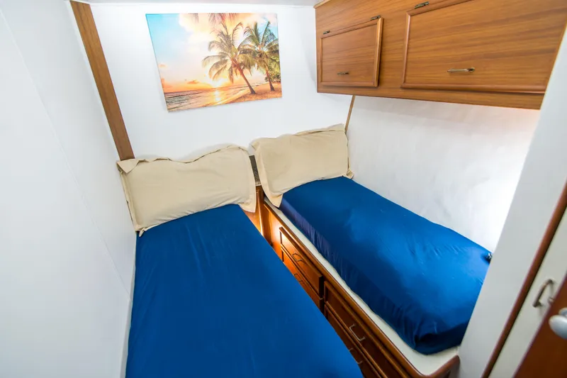 Slide: The Image of Twin beds in a cozy cabin of a 1986 Ocean Yachts 48 Super Sport. - 27