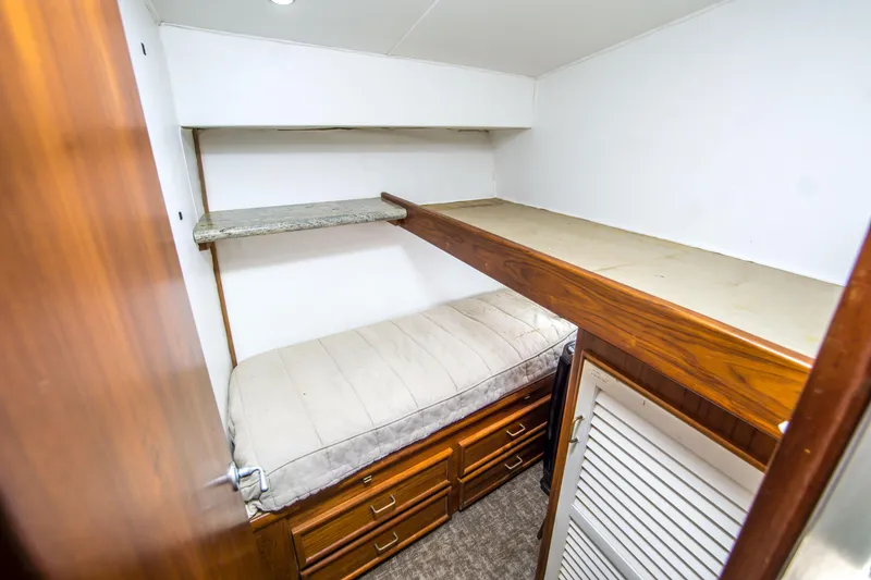 Slide: The Image of 1986 Ocean Yachts 48 Super Sport cabin with bunk beds and wooden storage drawers. - 29