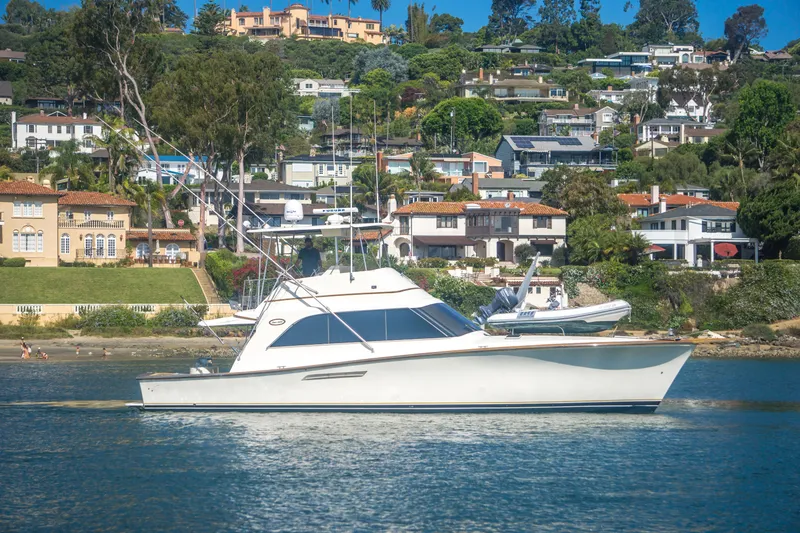 Slide: The Image of 1986 Ocean Yachts 48 Super Sport cruising near scenic waterfront homes. - 3