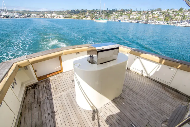 Slide: The Image of 1986 Ocean Yachts 48 Super Sport yacht deck with scenic marina view. - 7