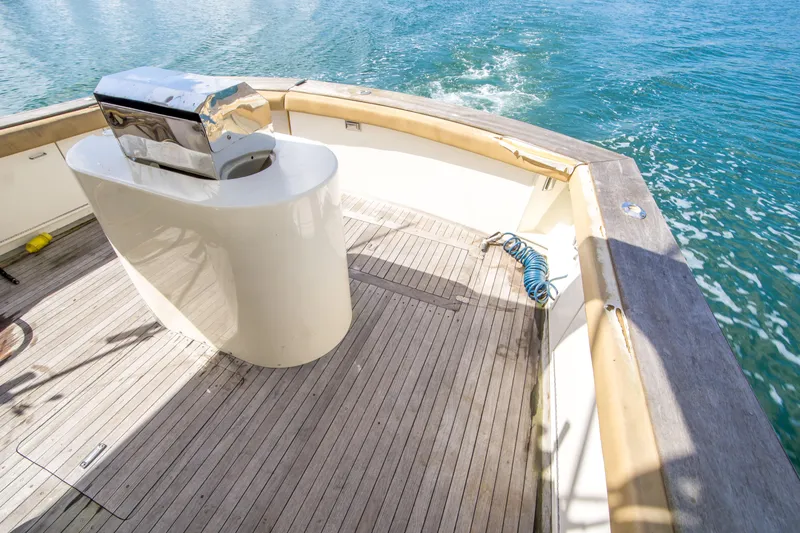 Slide: The Image of 1986 Ocean Yachts 48 Super Sport deck with grill, overlooking blue ocean waters. - 8