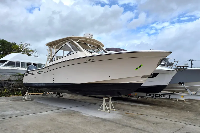 The Image of 2022 Grady-White Freedom 335 boat on display, for sale sign visible. - 1
