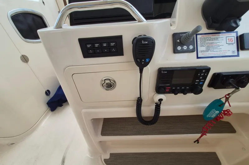 Slide: The Image of Control panel of 2022 Grady-White Freedom 335 boat with radio and switches. - 10