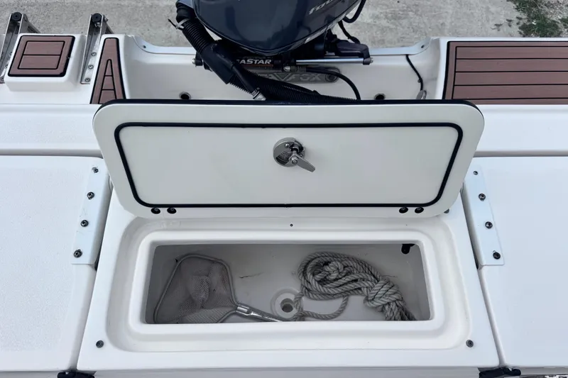 Slide: The Image of Open storage compartment on a 2018 Sea Fox 206 Commander boat with rope and net. - 29