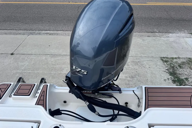 Slide: The Image of 2018 Sea Fox 206 Commander with Yamaha 175 outboard motor, docked on pavement. - 31