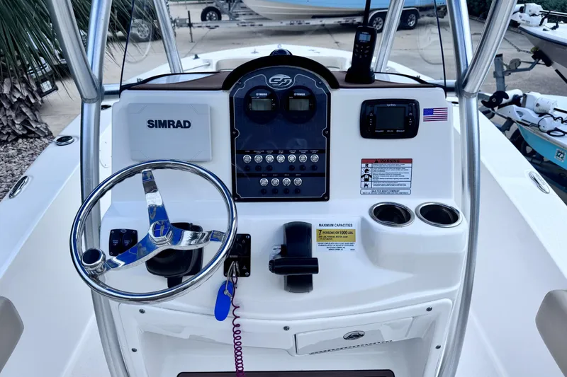 Slide: The Image of 2018 Sea Fox 206 Commander boat console with steering wheel and navigation controls. - 7