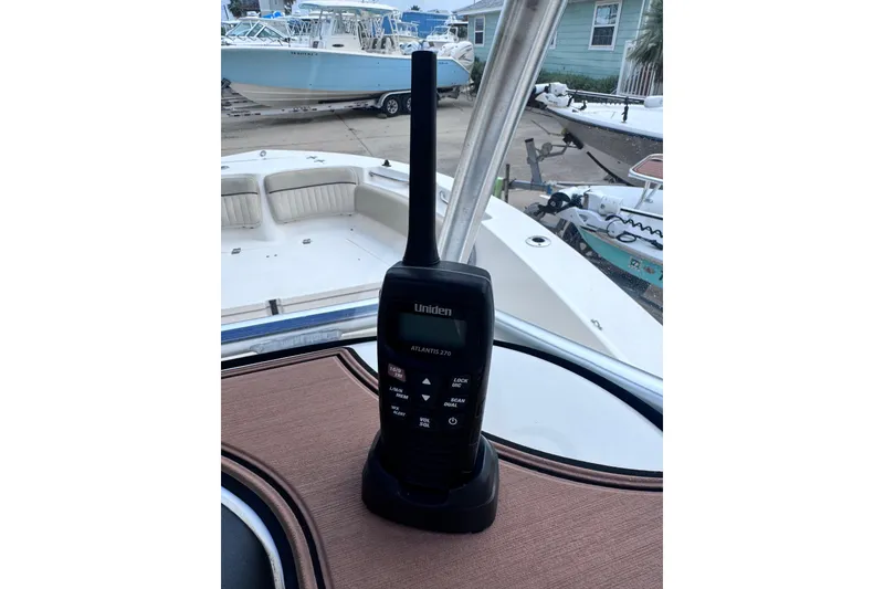 Slide: The Image of Handheld radio on 2018 Sea Fox 206 Commander boat deck, marina background. - 9