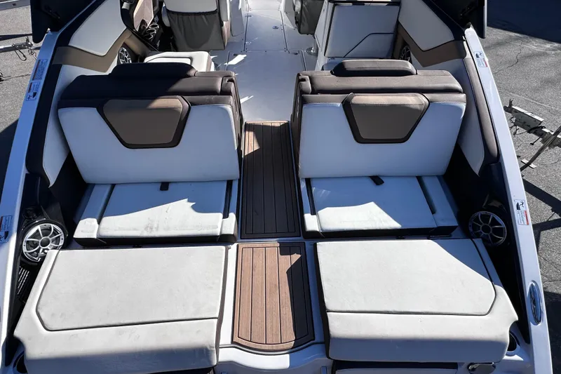 Slide: The Image of 2021 Yamaha Boats 252SD interior with cushioned seating and wood accents. - 10