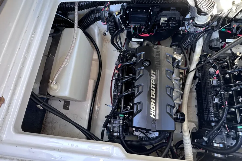 Slide: The Image of Engine compartment of a 2021 Yamaha Boats 252SD, featuring a high output engine. - 16