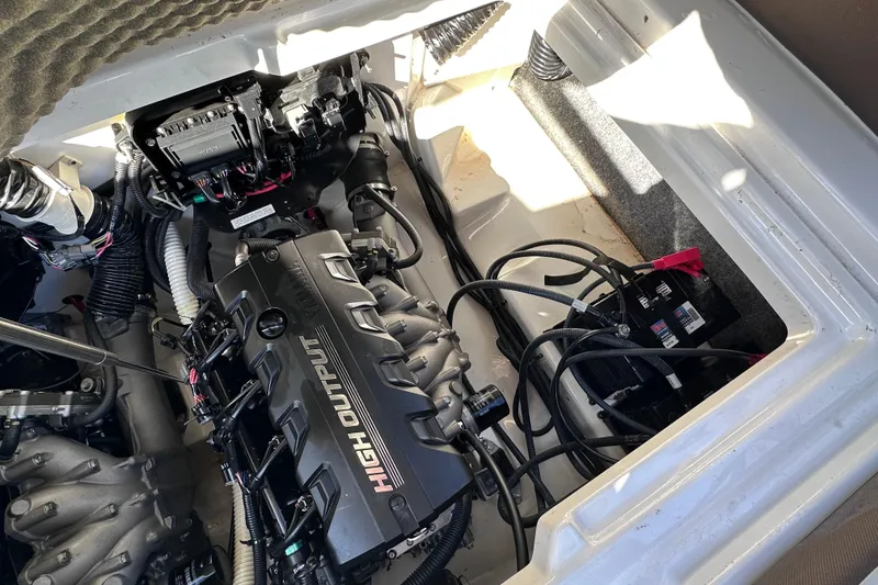 Slide: The Image of Engine compartment of a 2021 Yamaha Boats 252SD, featuring a high output engine. - 17