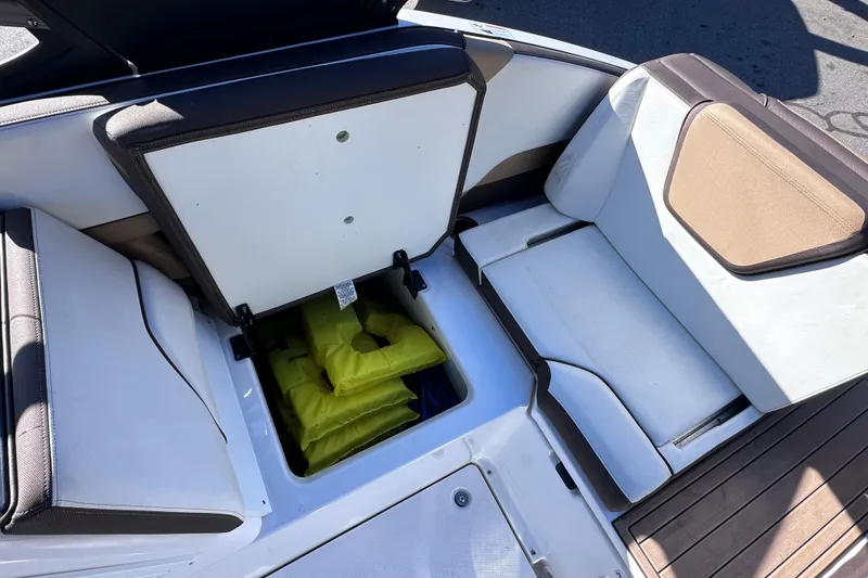 Slide: The Image of 2021 Yamaha Boats 252SD interior storage with yellow life jackets visible. - 20
