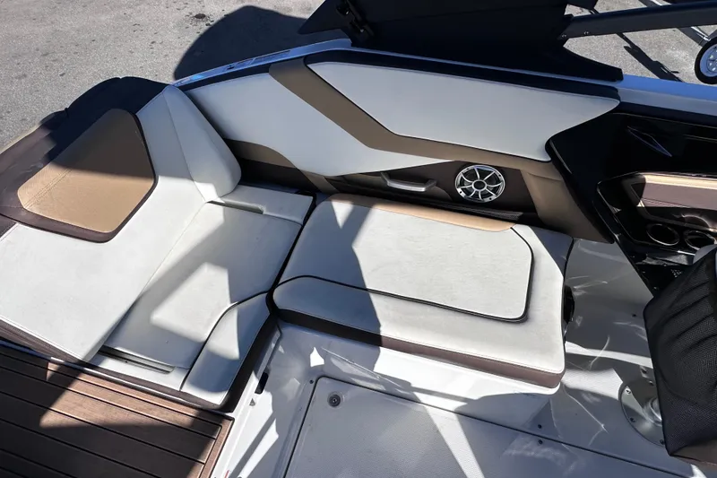 Slide: The Image of Interior seating of 2021 Yamaha Boats 252SD, featuring modern design and speaker system. - 21