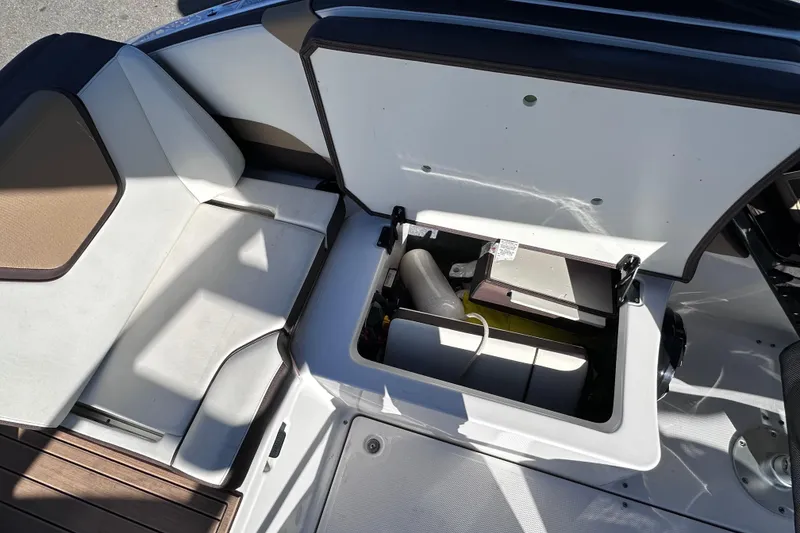 Slide: The Image of 2021 Yamaha Boats 252SD storage compartment with open hatch, showcasing interior space. - 22
