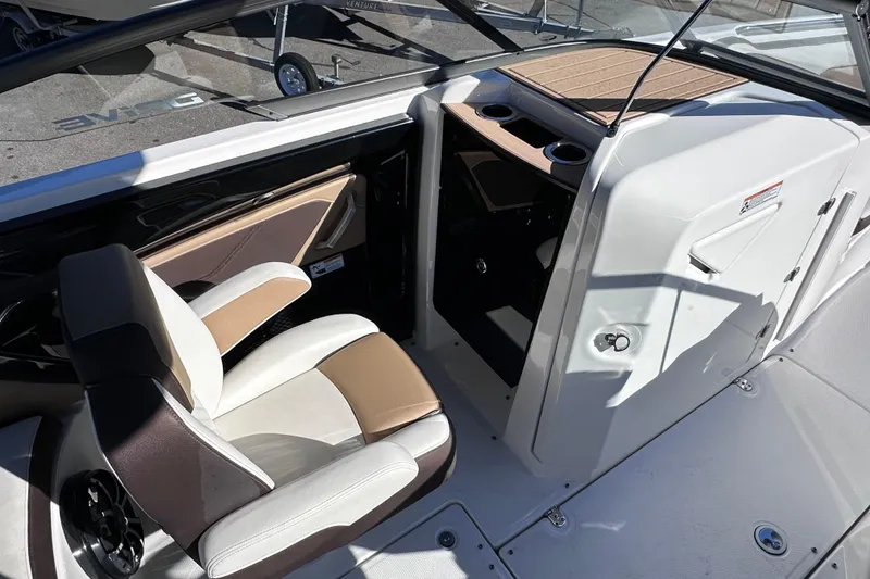Slide: The Image of 2021 Yamaha Boats 252SD interior with helm seat and storage compartment. - 25