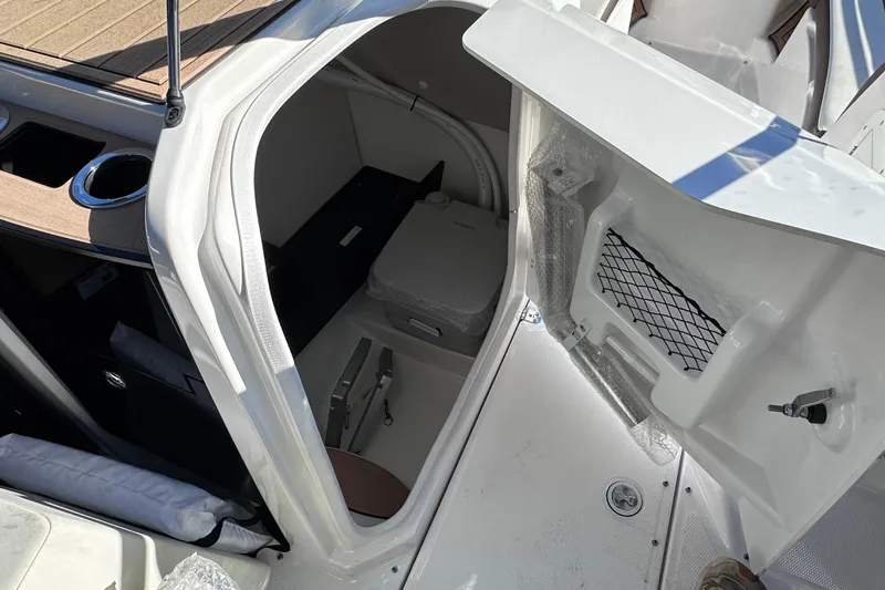 Slide: The Image of 2021 Yamaha Boats 252SD interior cabin with storage and seating area. - 26