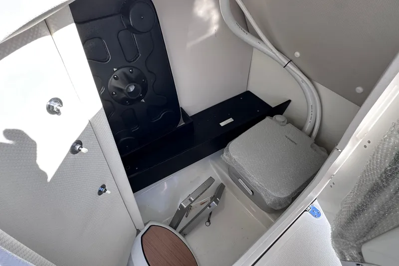 Slide: The Image of Interior of 2021 Yamaha Boats 252SD, featuring storage compartment and marine equipment. - 27