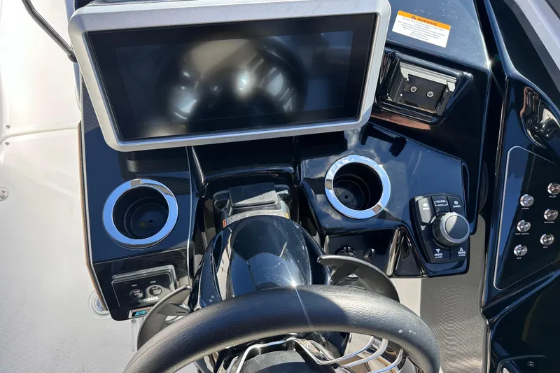 Slide: The Image of 2021 Yamaha Boats 252SD dashboard with touchscreen, controls, and cup holders. - 29