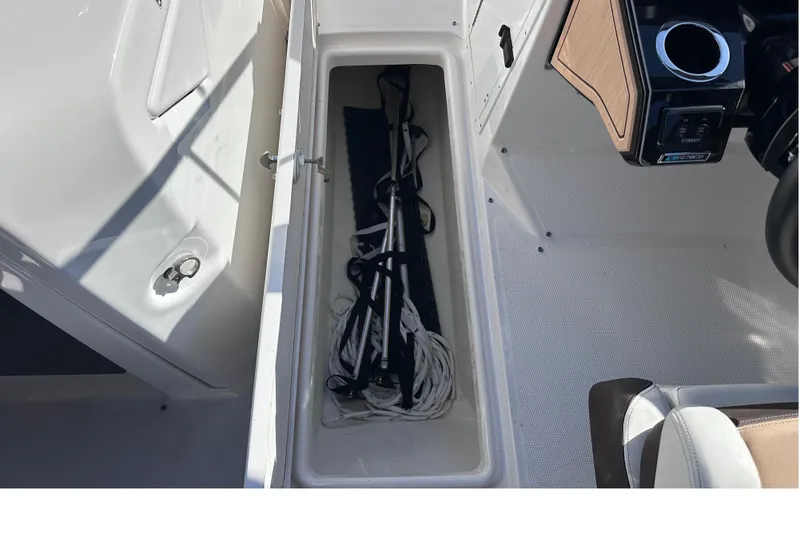 Slide: The Image of Storage compartment in 2021 Yamaha Boats 252SD, featuring ropes and accessories. - 30