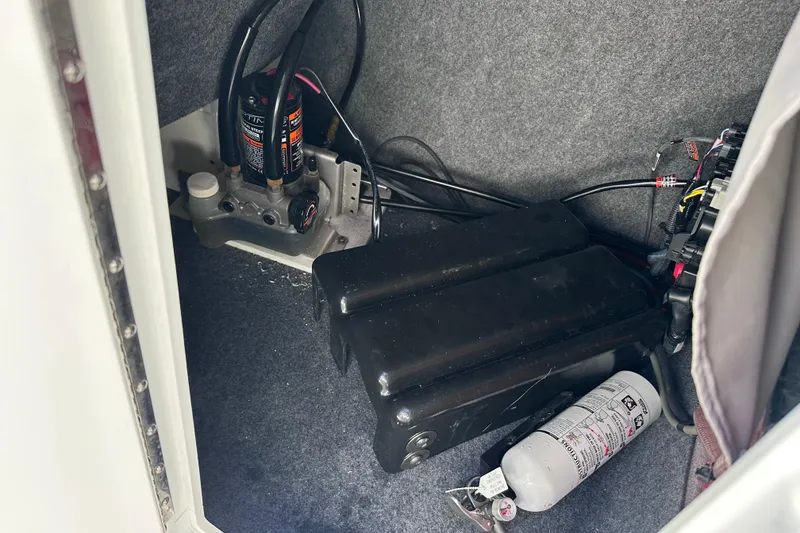Slide: The Image of Interior view of a 2021 Yamaha Boats 252SD, showing equipment and fire extinguisher. - 31