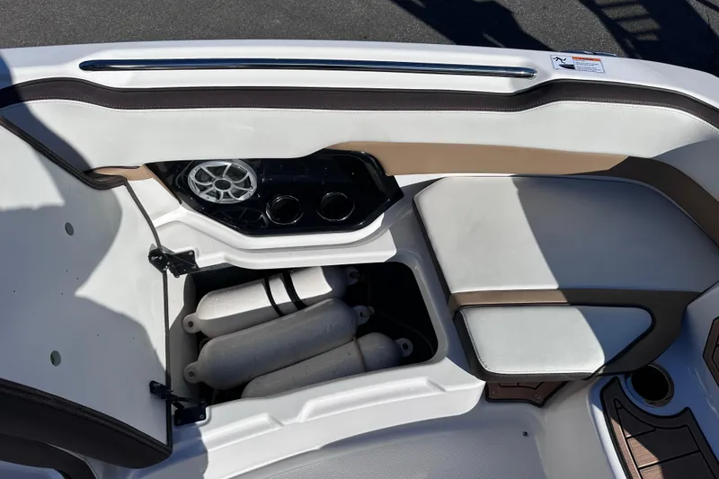 Slide: The Image of 2021 Yamaha Boats 252SD interior with storage compartment and speaker system. - 33