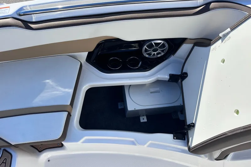 Slide: The Image of 2021 Yamaha Boats 252SD interior storage compartment with speaker and cup holders. - 34